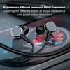 Close-up of black in-ear headphones with gold accents resting on a smartphone screen displaying abstract art. Produktbild-Vorschau