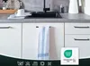 A kitchen scene with a sink, cabinets, and a towel hanging on a cabinet door. There is also a certification logo in the bottom right corner. Produktbild-Vorschau
