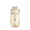 A baby bottle with a straw and a crown-shaped lid, presented against a white background. Produktbild-Vorschau