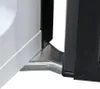 Close-up of the bottom corner where a white appliance meets a black frame, with a silver metal bracket connecting them. Produktbild-Vorschau