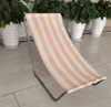 A striped beach chair is placed on a tiled floor in front of potted plants. Podgląd zdjęcia produktu