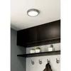 A ceiling light fixture mounted on a white ceiling above black cabinets and shelves. Produktbild-Vorschau