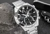 A close-up shot of a Casio Edifice watch resting on a textured gray surface, with a dark background and a hint of a black object in the upper right corner. Voir les images du produit