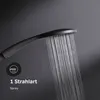 A close-up shot of a black shower head with water spraying from it against a dark gray textured background. A circular icon with a shower head graphic and text indicating '1 Strahlart' and 'Spray' is present in the lower left corner. Produktbild-Vorschau