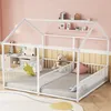 A child's house-shaped bed with two mattress areas and safety rails, decorated with stuffed animals and pillows. Produktbild-Vorschau