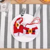 Christmas-themed cutlery holders on a plate, set on a striped table runner. Produktbild-Vorschau