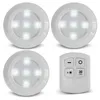 A set of three white LED puck lights and a remote control are displayed on a white background. Produktbild-Vorschau