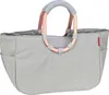 A light gray reisenthel shopping bag with rose gold and light gray handles, shown from the front against a white background. Podgląd zdjęcia produktu