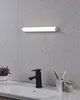 A bathroom vanity with a sink, faucet, and a light fixture above. Podgląd zdjęcia produktu