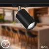 A black track light fixture is shown in a blurred kitchen background. Anteprima dell’immagine prodotto