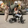 Two babies are on a carousel with a tricycle. Produktbild-Vorschau