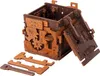 A 3D wooden puzzle box with gears and mechanical components is shown assembled, with some loose pieces in the foreground. Produktbild-Vorschau