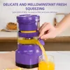 A person is using a purple and yellow electric juicer to make orange juice, which is being poured into a glass. Podgląd zdjęcia produktu
