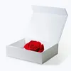 A red rose is placed inside an open white gift box. Produktbild-Vorschau
