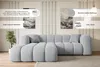A light gray sectional sofa is shown in a well-lit living room setting with decorative elements. Produktbild-Vorschau