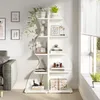 A white wavy bookshelf filled with decorative items and plants, next to a sofa and a window. Podgląd zdjęcia produktu