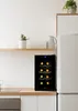 A small wine cooler sits on a kitchen counter next to a refrigerator. Voir les images du produit