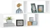 A white modular shelving unit with decorative items on display. Voir les images du produit