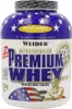 A tub of Weider Premium Whey protein powder with a vanilla-caramel flavor. Produktbild-Vorschau