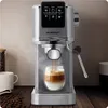 A silver espresso machine is brewing coffee into a glass cup, with coffee beans and a white mug in the background. Anteprima dell’immagine prodotto