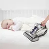 A baby sleeping in a crib with a vacuum cleaner next to it. Náhled obrázku produktu
