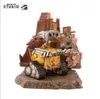 A Wall-E collectible figure is displayed on a rocky base with a backdrop of debris and ruined buildings. Anteprima dell’immagine prodotto