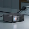 A multi-port USB charger with a digital display is plugged into a wall outlet. Produktbild-Vorschau