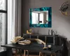 A dining room setting with a mirror on the wall, a table with books, and a cabinet. Produktbild-Vorschau