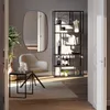 A modern living room setting with a chair, shelf, and table. Voir les images du produit