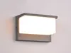 A modern outdoor wall light fixture mounted on a light gray wall. Podgląd zdjęcia produktu