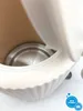 Close-up view of the inside of a white electric kettle, showing the metal heating element. Náhľad obrázku produktu