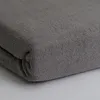 A close-up, folded gray fabric, likely a bedsheet. Produktbild-Vorschau