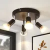 A ceiling light fixture with four adjustable spotlights is mounted on a white ceiling. Produktbild-Vorschau