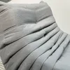 Close-up of a grey tufted sofa or armchair. Produktbild-Vorschau