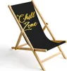 A black sling chair with "Chill Zone" text in gold, set against a white background. Produktbild-Vorschau