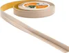 A roll of beige flexible skirting board with adhesive backing, with a section unrolled and bent into an L-shape. Náhled obrázku produktu