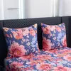 A close-up view of a bed with floral patterned bedding and pillows. Náhled obrázku produktu