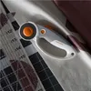 A close-up of a Fiskars rotary cutter on fabric next to a quilting ruler. Produktbild-Vorschau