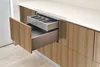 Close-up of kitchen cabinets with drawers open, revealing cutlery organizers. Podgląd zdjęcia produktu