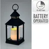A black lantern with a lit candle inside, shown against a light gray background. To the right are two informational graphics about the product's features. Náhled obrázku produktu