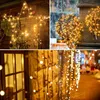 A collage of images showing decorative string lights in various settings, including a star shape on a wooden wall, spherical arrangements, and hanging strands along a building and street. Produktbild-Vorschau