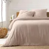 A neatly made bed with beige musselin bedding in a bedroom setting. Náhľad obrázku produktu