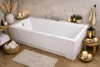 A modern bathroom with a white bathtub, decorated with candles, plants, and towels. Produktbild-Vorschau