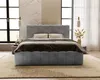 A modern bedroom with a large gray upholstered bed as the focal point. Náhled obrázku produktu