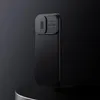A black iPhone case with a textured back and a camera cover is displayed against a dark background. Náhled obrázku produktu