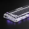 A close-up, angled view of a white and black mechanical keyboard with purple backlighting. Náhled obrázku produktu