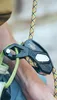 A close-up shot of a climbing device attached to a rope, with a person's arm and shoulder visible in the background. Náhľad obrázku produktu