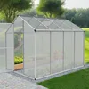 A greenhouse in a garden setting with plants inside. Produktbild-Vorschau
