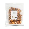 A clear plastic bag containing twisted dog treats, with a white label in the center. Náhled obrázku produktu