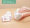 A hand is shown using a portable bottle warmer to dispense a wipe, with a stack of baby wipes in the foreground. Náhľad obrázku produktu